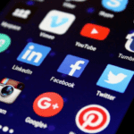 Alt Text: "Smartphone displaying social media evolution timeline in a modern office setting, highlighting AI automation and cybersecurity themes."