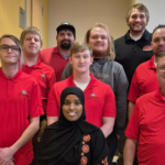 "St. Cloud State cybersecurity contest victory symbolized by a team managing mock networks, tackling cyberattacks, and excelling under pressure."