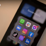 alt text: "Modern office setting in Bangkok with a blurred background and a smartphone displaying digital marketing analytics, symbolizing top social media marketing agencies in Bangkok."