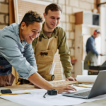 Alt Text: "A laptop displaying automation software alongside a smartphone and planner, representing top tools to automate small business tasks."