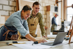 Alt Text: "A laptop displaying automation software alongside a smartphone and planner, representing top tools to automate small business tasks."