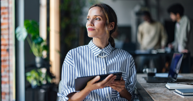 Alt Text: "Financial advisor using social media strategies on a smartphone, analyzing engagement data to enhance business growth and credibility."