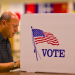 **Alt Text:** "Election security workers under review, symbolized by a dimly lit office with cybersecurity graphics, reflecting temporary removal."