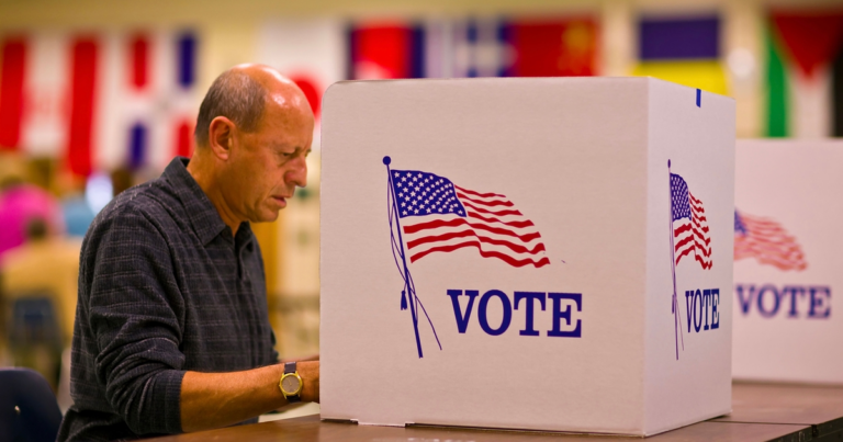 **Alt Text:** "Election security workers under review, symbolized by a dimly lit office with cybersecurity graphics, reflecting temporary removal."