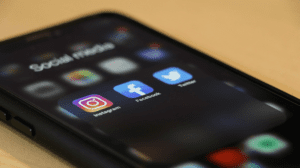 SEO-Optimized Alt Text: "Smartphone screen showing misleading influencer post, highlighting the downsides of social media influencers like false promotions and privacy risks."